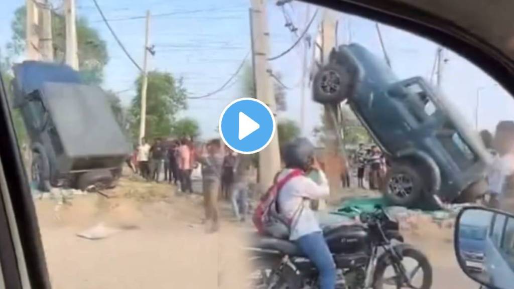 Woman Driven Mahindra Thar SUV stuck on a roadside pole after it collided with Honda Amaze vehicle Watch This Dramatic Video