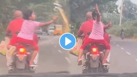 little girl is doing the dance while sitting on the back of the bike