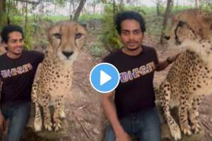 The young man went to the forest and took a picture with cheetah