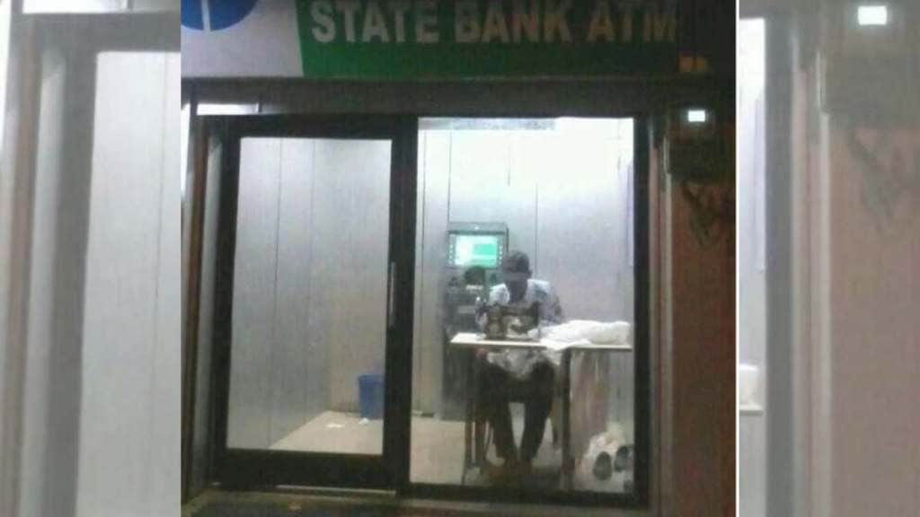 viral photo man doing tailoring work in sbi bank atm