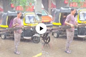 a man carries Hand Cart Pushers in heavy rain