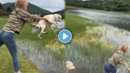 young woman threw the dog in the lake