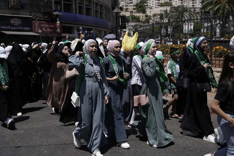 Palestinians wear Hamas militant group scarves and headbands as they protest the assassination of Hamas top leader Ismail Haniyeh, in the West Bank city of Nablus, Wednesday, July 31, 2024.