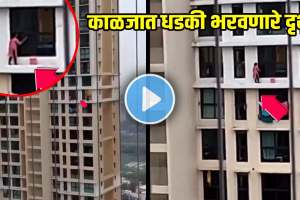 woman standing outside 16th floor window to clean