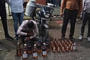 police arrested bike rider who smuggling liquor in milk cans