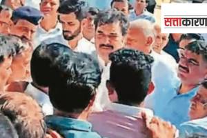 BJP leaders Kuldeep and Bhavya Bishnoi with a group of villagers in their constituency Adampur on Monday. (Express Photo