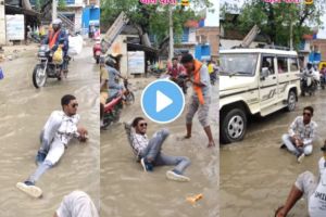 A young guy did a photo shoot in the water flooding on the road