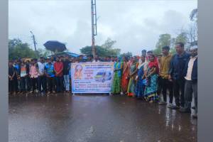 plaque noted 108 lost ambulances at Borgaon Health Centre garlanded during rainy protest