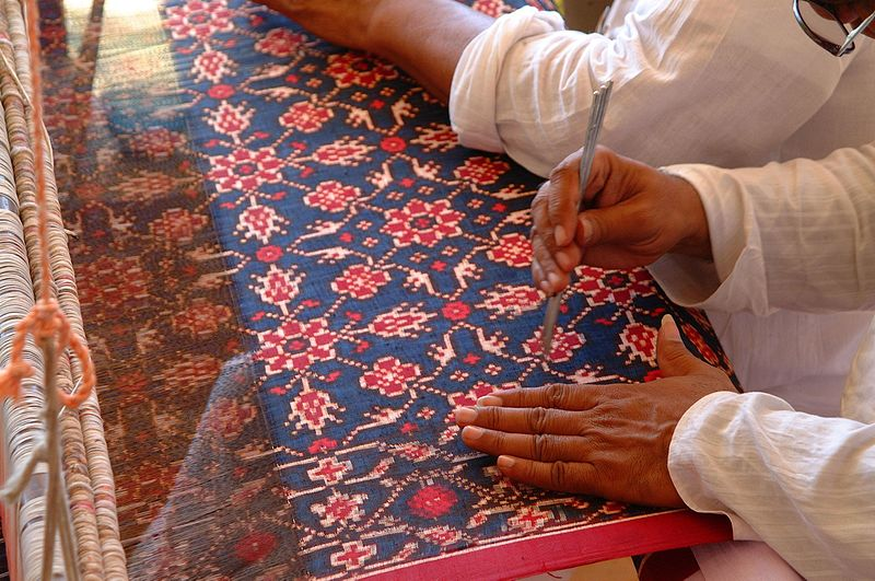 Indian textile artists demonstrate double ikat patola weaving.