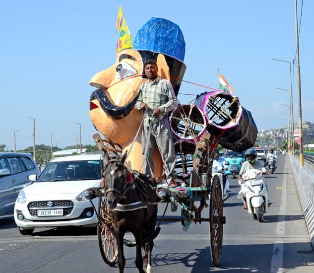 A horse-cart driver transports an effigy of Ravana ahead of the Dussehra festival.