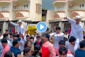 Video an old man dance in varaat wedding by sitting on young mans shoulders