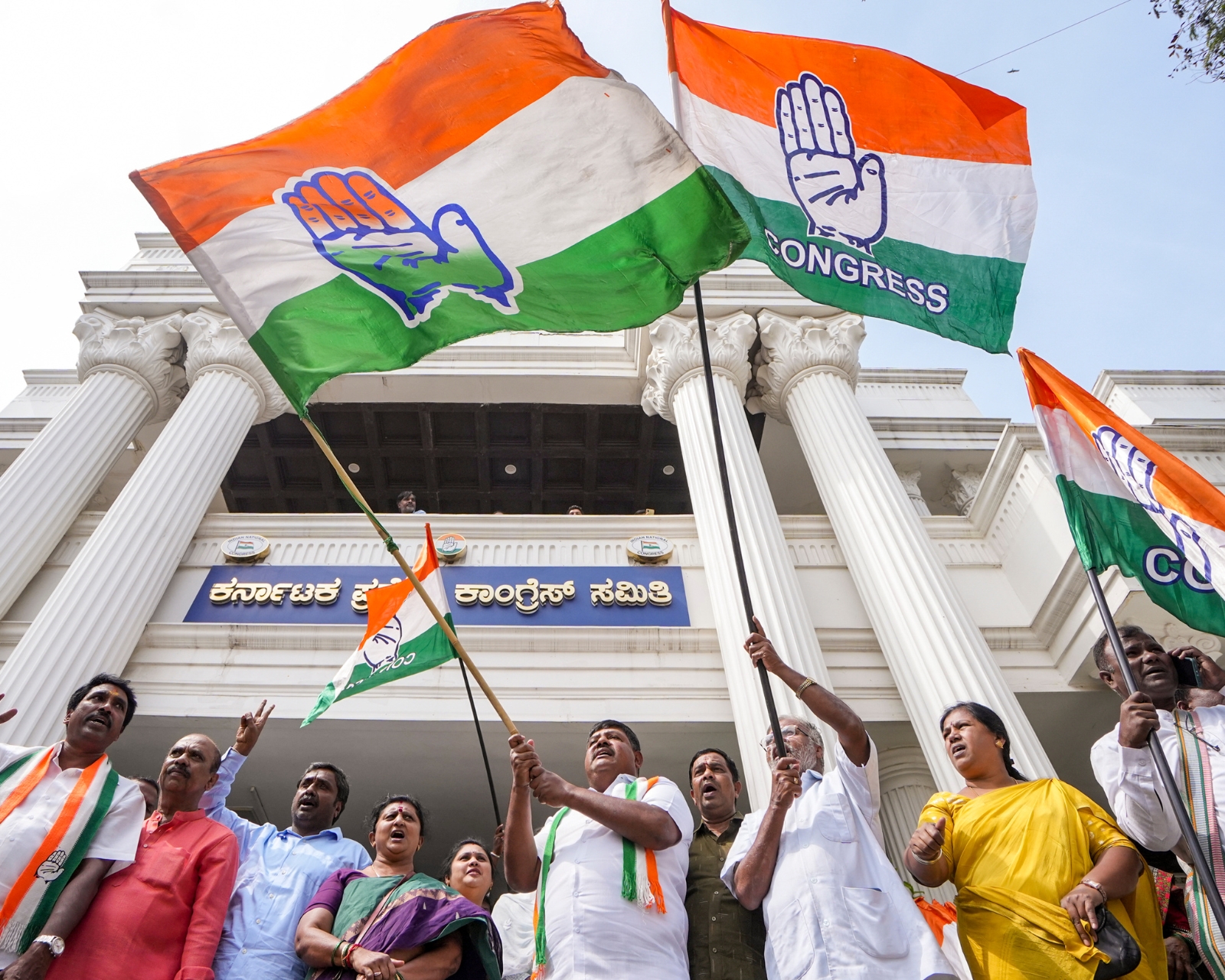 Congress party members rejoice following the party's victory in all three assembly by-elections in Bengaluru, Karnataka, (Photo credit: PTI)