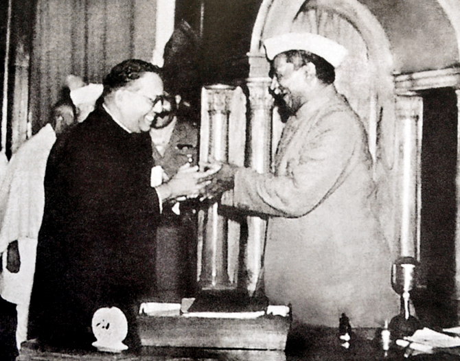 Babasaheb Ambedkar, chairman of the drafting committee, presenting the final draft of the Indian constitution to Constituent Assembly president Rajendra Prasad on 25 November 1949