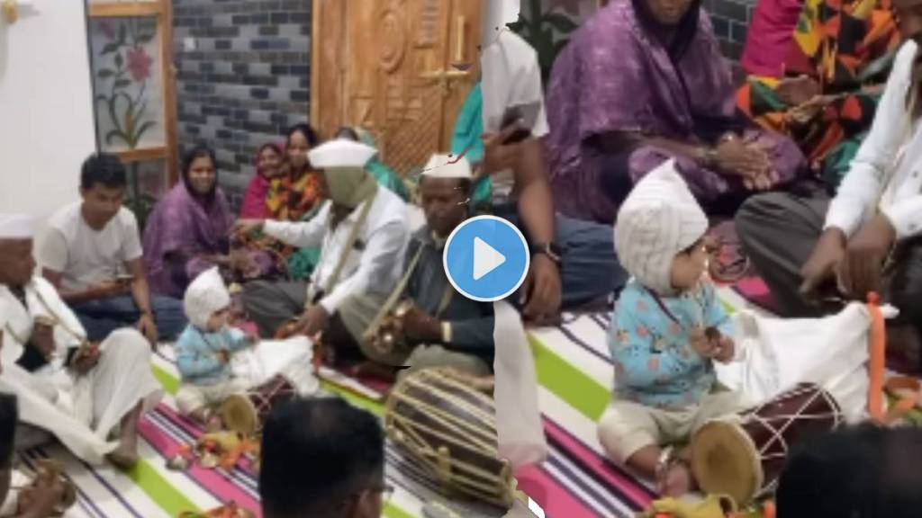 little boy shaking his head while listening to the bhajan