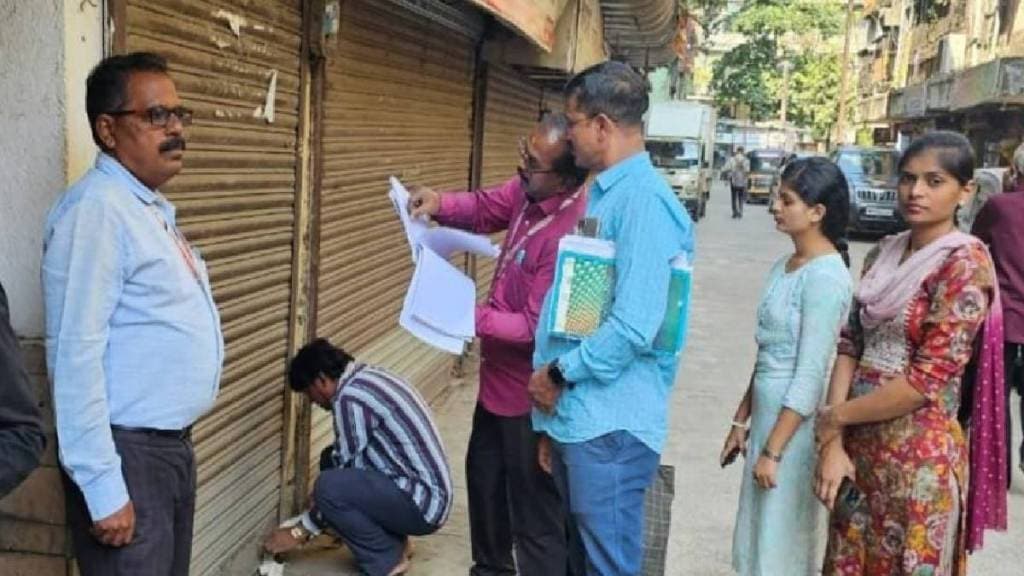 Municipal employees sealing a property in Kalyan East