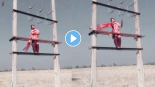 a young girl dance on a electric pole