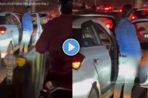 a man urinating near the gate of his car in heavy traffic on a road