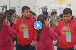 e a man holding mirror for a wife while doing makeup in mahakumbh mela