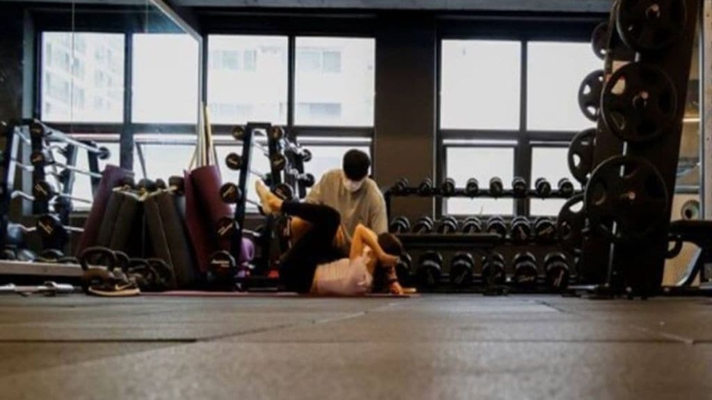 Image of a woman trainer in a gym or swimming pool