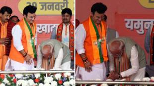 Modi touches Patparganj candidate feet