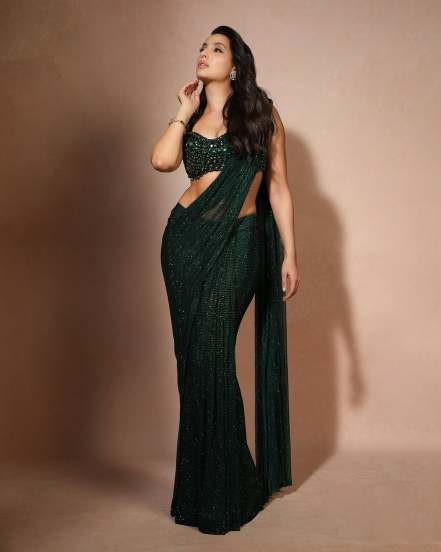 Nora Fatehi shares pictures in green designer saree on social Media for her release of new song snake