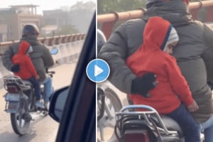 Father holds child with one hand while driving a bike with other shocking video viral on social media