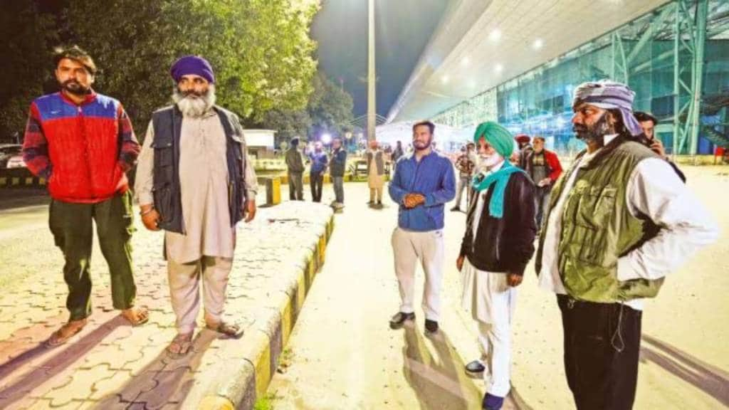 Relatives wait outside the airport ahead of the second batch of the immigrants' arrival from the US, in Amritsar, Saturday