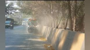 Pimpri chinchwad municipal corporation sprays water to reduce pollution while road sweepers blow dust