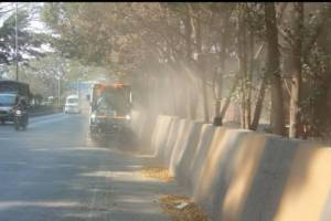 Pimpri chinchwad municipal corporation sprays water to reduce pollution while road sweepers blow dust