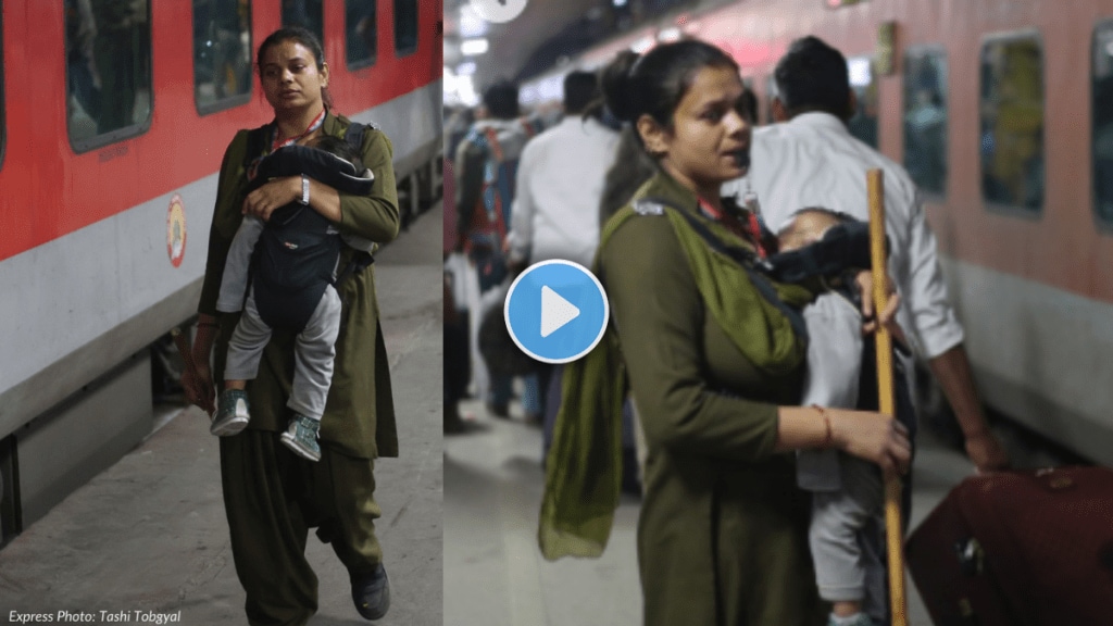 RPF woman constable patrols crowded New Delhi Railway Station platforms with baby in carrier