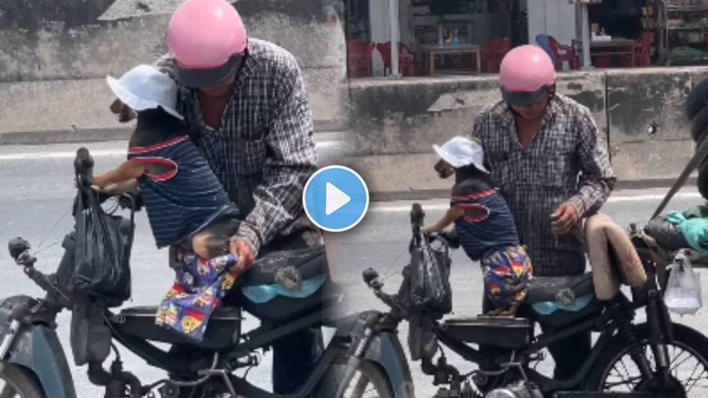 Man dresses puppy in T shirt and pants