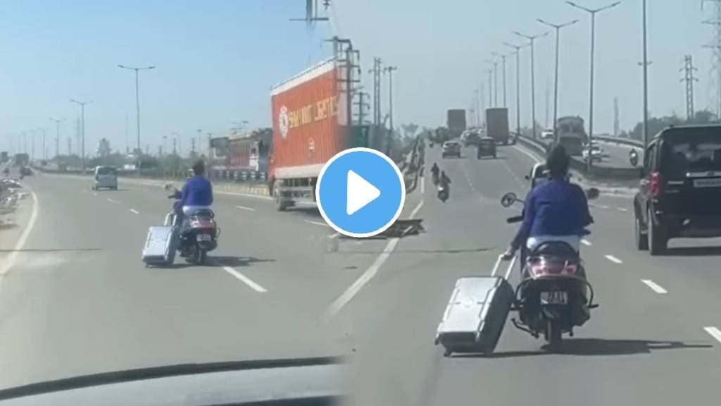 indian jugaad girl drive a scooty with one hand and a suitcase with the other vidoe on the highway goes viral