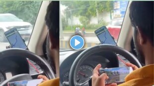 The video shows Google Maps running on one phone while the driver plays the game on another smartphone